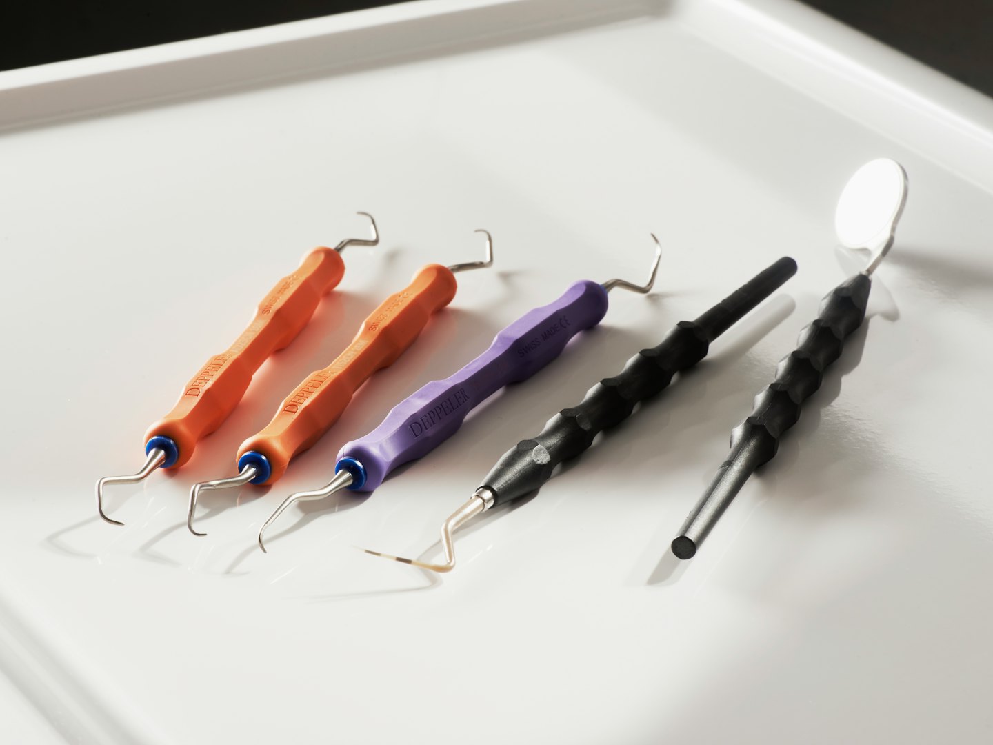 Dental tools arranged on a white medical tray.